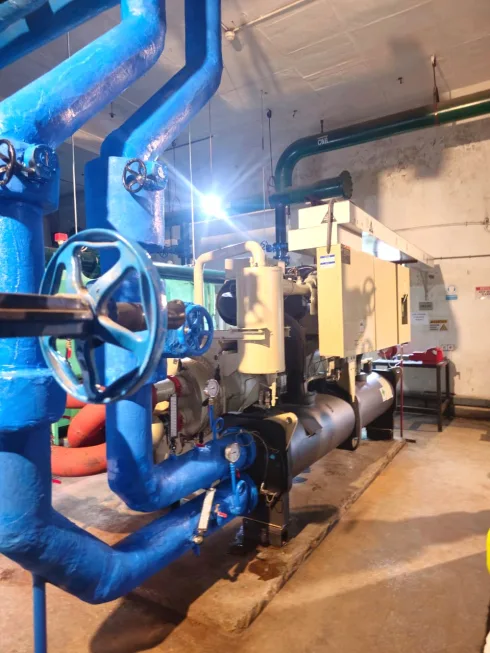 Chilled water piping with valves and gauges in a plant room